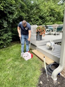 Ohio Pet Waste Pros dog waste cleanup service scooping with client's dog in Sylvania
