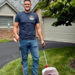 Ohio Pet Waste Pros owner with scooping bucket and rake in Sylvania, Ohio