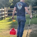 pooper scooper cleaning a client's yard in Maumee, OH with a bucket and rake