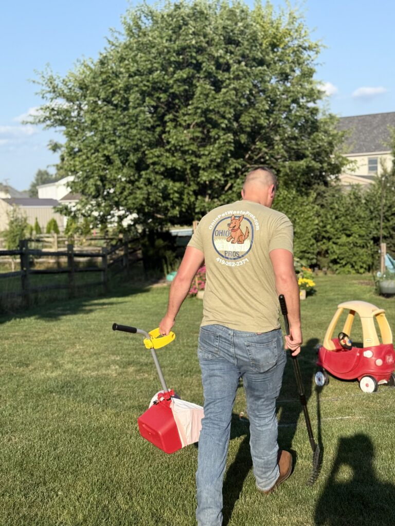 Pooper scooper technician cleaning pet waste from a yard to make it clean and safe for kids