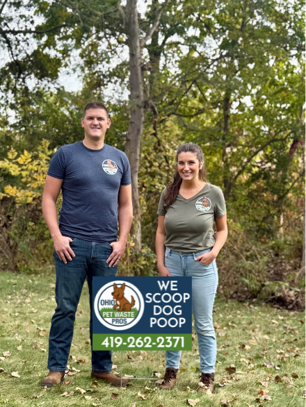 Dog poop removal scoopers with "we scoop dog poop" yard sign