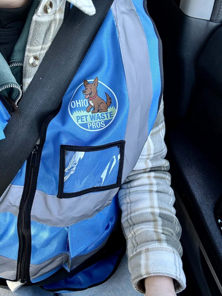 local pooper scooper at ohio pet waste pros wearing a branded work jacket