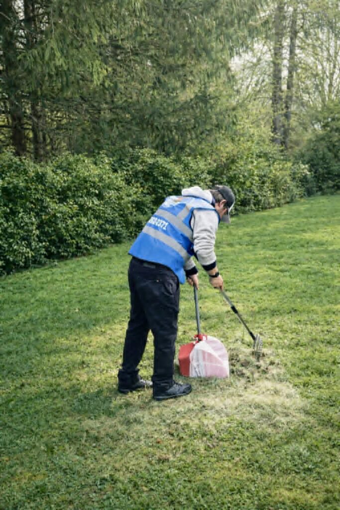 poop er scooper technician scooping dog poop